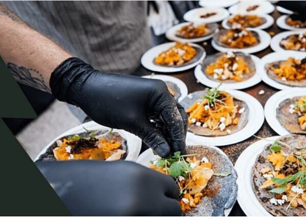 Persons hands plating a dish